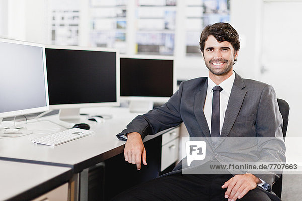 Businessman smiling at desk