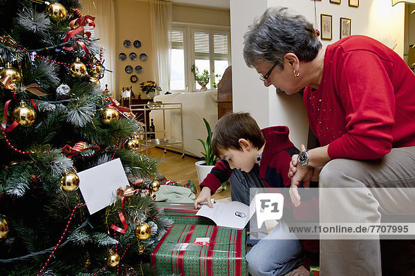 Woman and grandson with Christmas presents