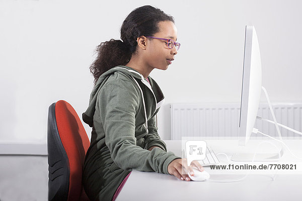 Girl using computer at desk