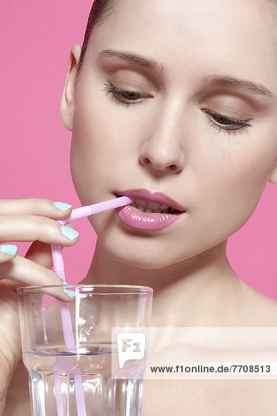 Close up of woman drinking with straw