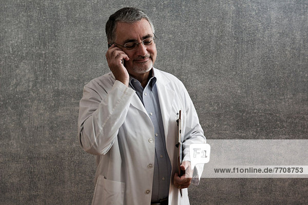 Male doctor on cellphone