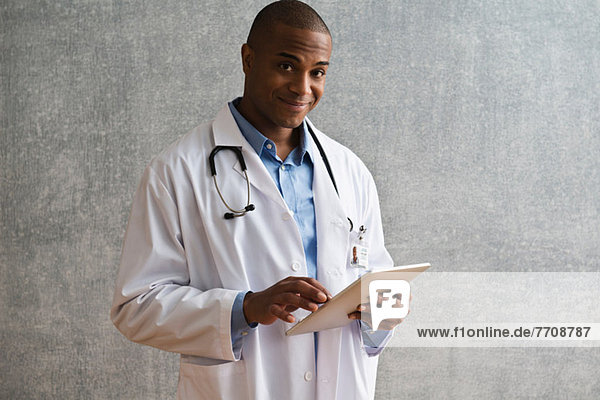 Portrait of male doctor with digital tablet