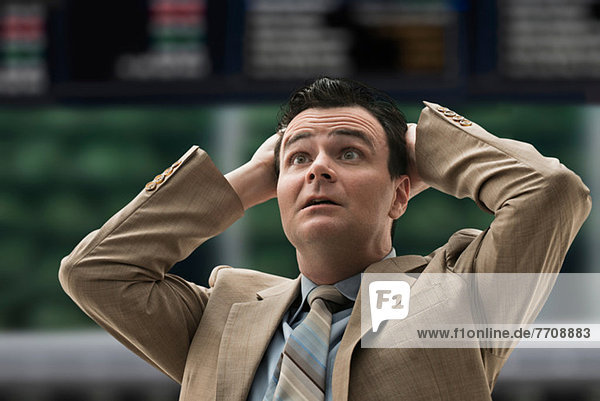 Stressed businessman at stock exchange