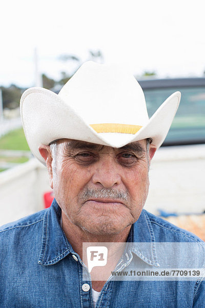 Farmer wearing cowboy hat outdoors