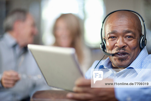 Older man wearing headset