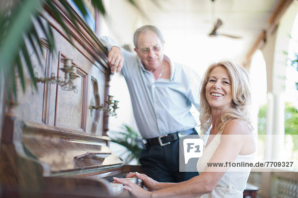 Älteres Paar beim Klavierspielen