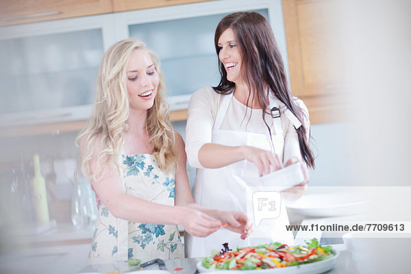Women cooking together in kitchen