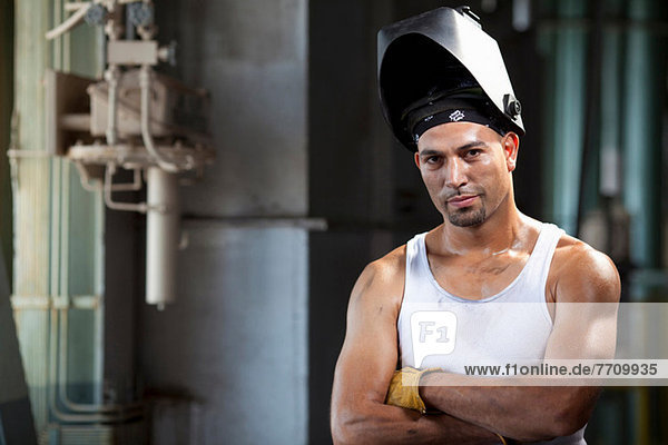 Industrial worker in welding helmet