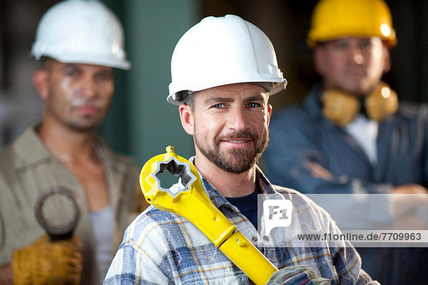 Industrial worker smiling in plant