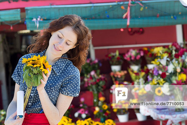 Florist mit Blumen im Geschäft