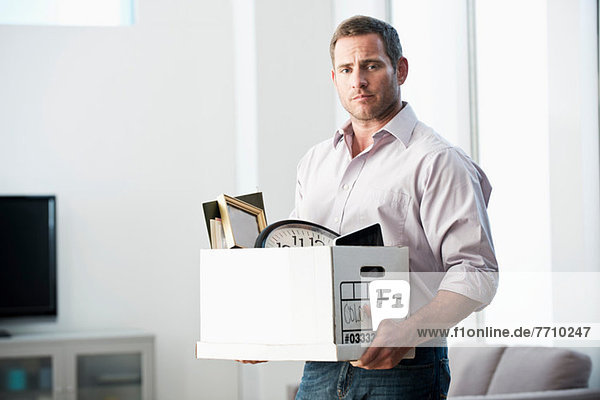 Businessman packing up box in office
