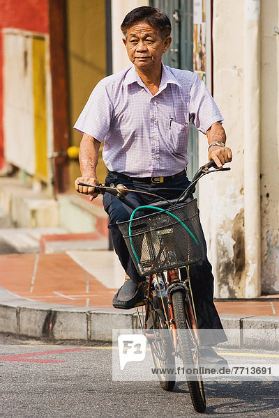Malaysia  View of man riding his bicycle  Malacca