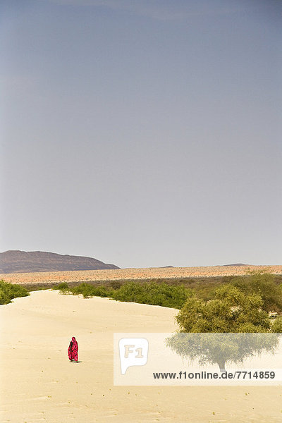 Woman Walking In Desert
