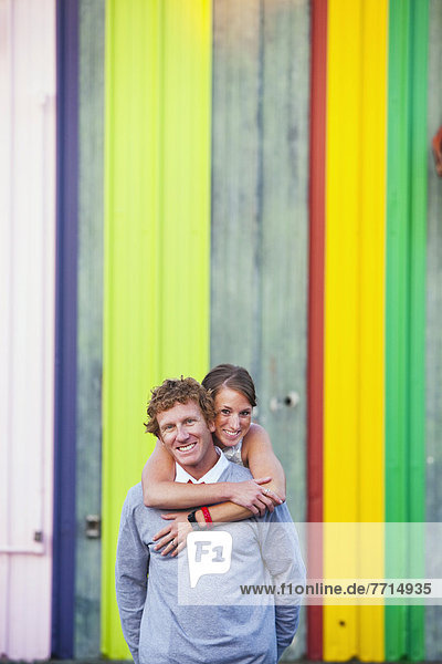 A Couple Embracing In Front Of A Colorful Background  Costa Mesa California Usa