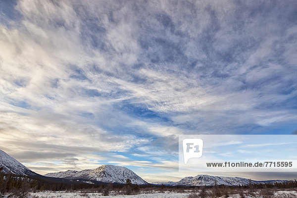 Winter scene with late afternoon clouds over the annie lake road  whitehorse yukon canada