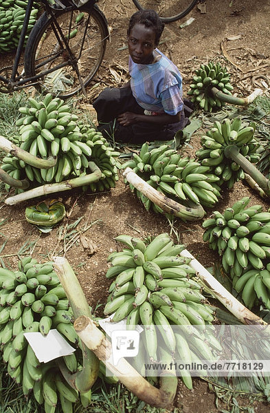 A Woman Sitting Amongst Bananas