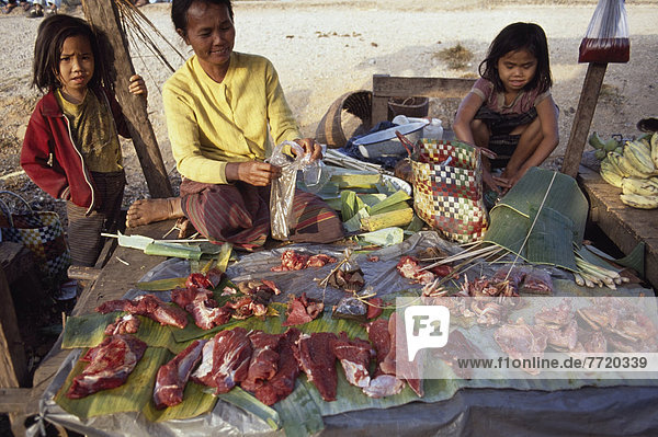 A Woman Vendor And Two Small Girls