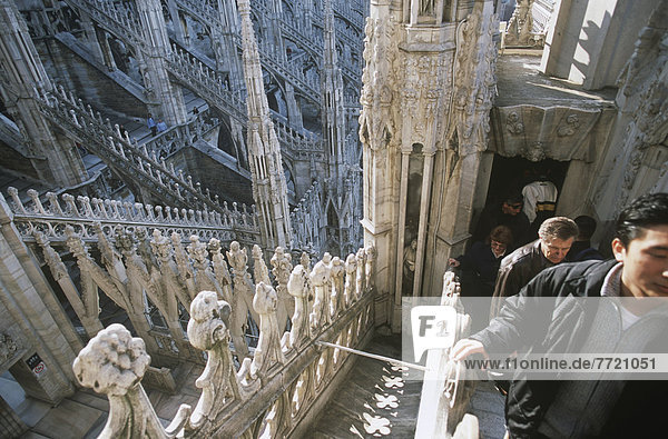 Young Men Walking Ontop Of The Roof Of Milan Cathedral
