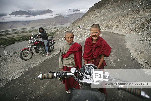 Royal Enfield Bullet Motorbike With Buddhist Boy Monks  Nubra Valley  Ladakh  India