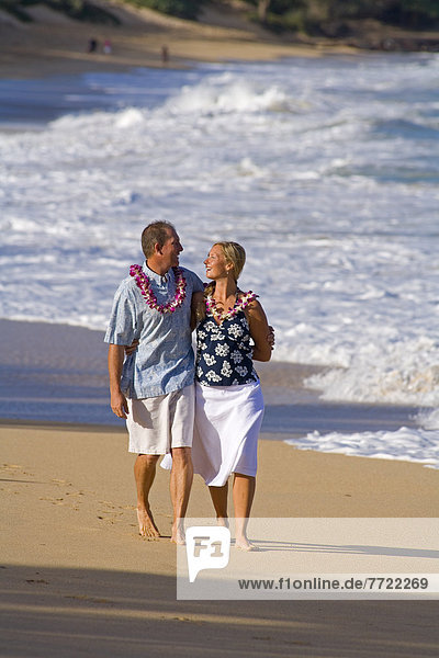 Hawaii  Maui  Baldwin Beach  Couple On Vacation Walking Down The Beach Holding Hands