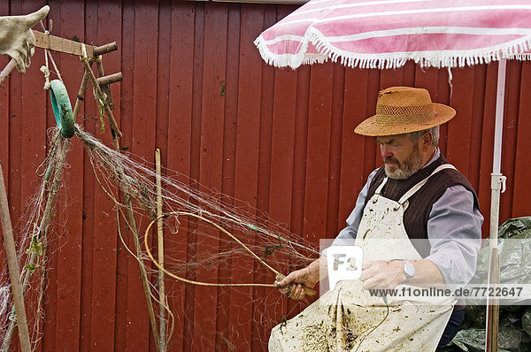 Fisherman Repairing His Nets Ringkobing  Situated Right By The Inlet Ringkobing Fjord   West Jutland Denmark