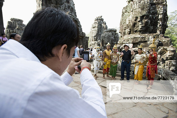People Taking Picture At Iconic Bayon Temple  Siem Reap  Cambodia