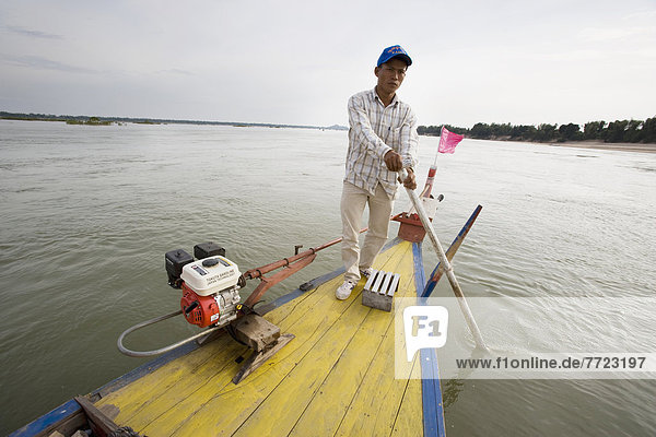 Man Sailing Fishing Boat On Mekong River  Kampi  Cambodia