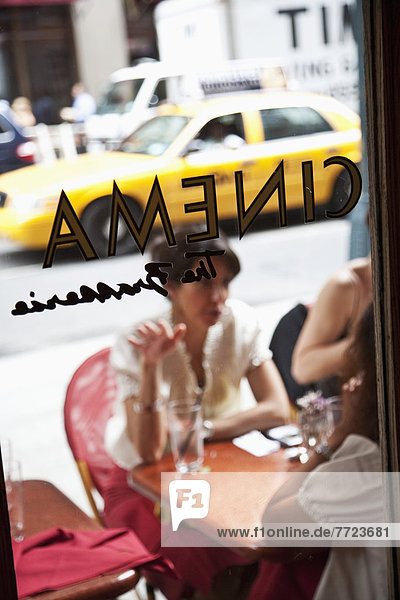 View Through A Window Of A Woman Sitting Outside Cinema Restaurant  New York City  New York City