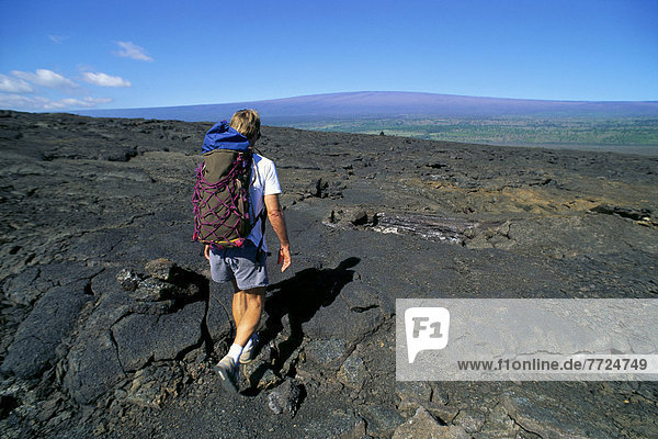 Hawaii  Big Island  Hawaii Volcanoes National Park  View Of Mauna Loa  Hiker Kau Desert Trail  Lava Field B1555. For Editorial Use Only.
