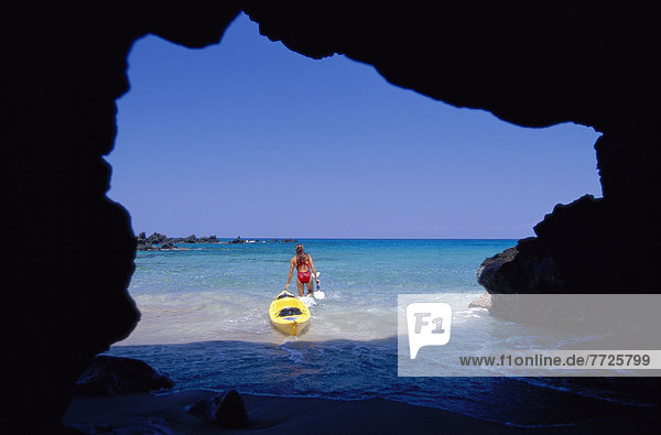 Hawaii  Big Island  Honomalino Bay  View From Behind Woman Heading Out With Yellow Kayak Sea Cave D1242