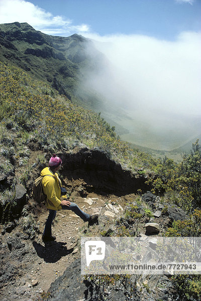 Hawaii  Maui  Haleakala National Park  Kalapawili Ridge Trail Hiker Overlooks Cloud Covering. For Editorial Use Only.