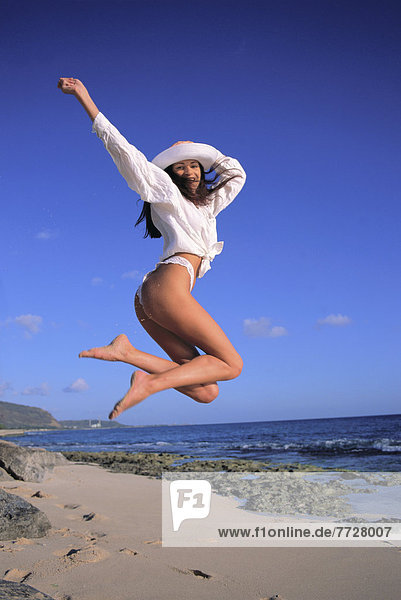 Young Woman Jumping In Air  Thong Bikini  White Top And White Hat