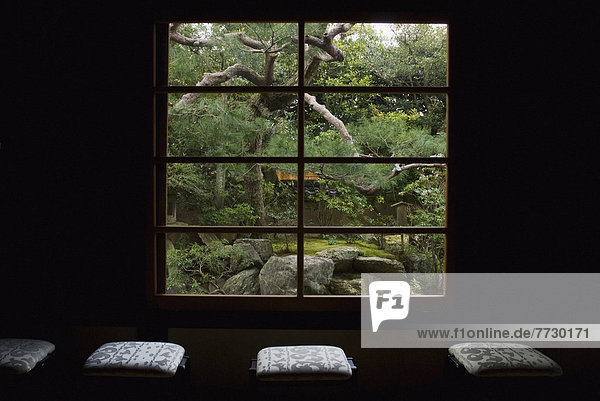 Zen Temple Garden Seen Through A Window With A Row Of Seat Cushions In Front  Kyoto  Japan