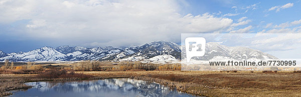 Panarama Of Mountains Reflected In A Lake  Bozeman Montana United States Of America