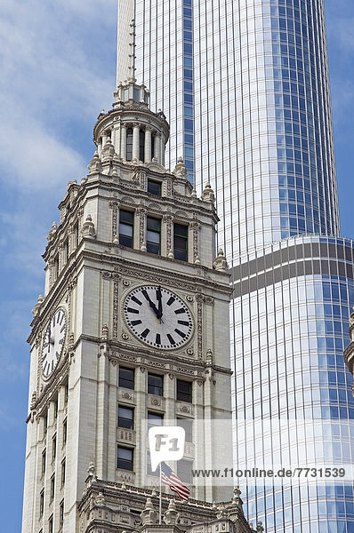 A Clock Tower With The American Flag Beside A Skyscraper  Chicago Illinois United States Of America