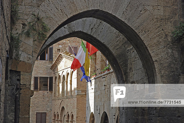 Arches In Stonework And Flags On The Edge Of A Building  San Gimignano Italy
