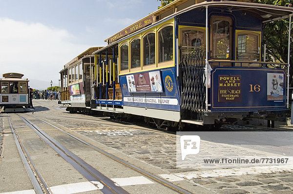Colourful San Francisco Cable Cars On Cobbled Stone Street  San Francisco California United States Of America