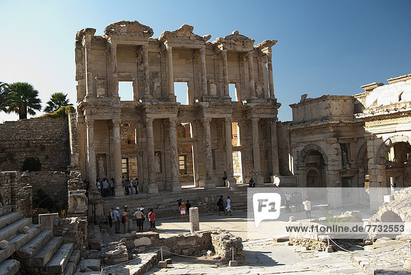 People walking in front of Celsus Library and Gate of Mazeus and Mithridates  Ephesus  Izmir Province  Turkey