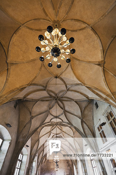Czech Republic  Low angle view of ornate ceiling and light fixture  Prague