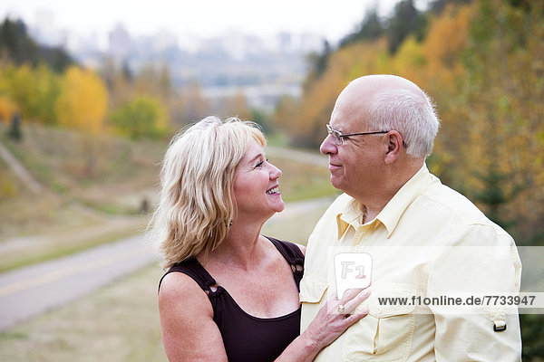 Mature Married Couple Enjoying Spending Time Together In Park During Fall Season  Edmonton  Alberta  Canada