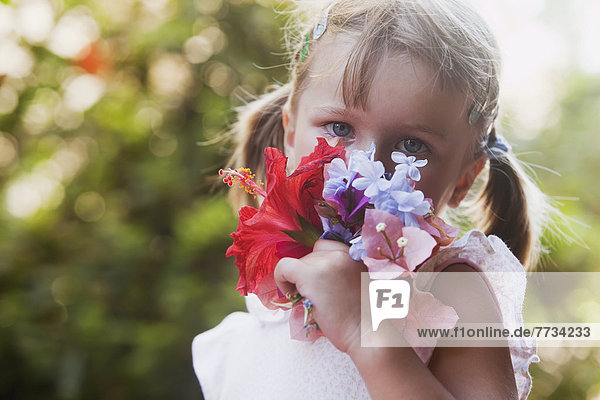 A Young Girl Smelling A Colourful Bouquet Of Flowers  Torremolinos  Malaga  Spain
