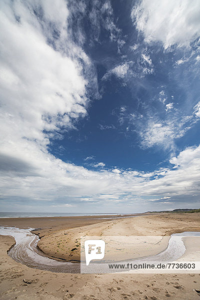 A Stream Formed In A Circular Shape In The Sand Along The Coast  Druridge Bay Northumberland England