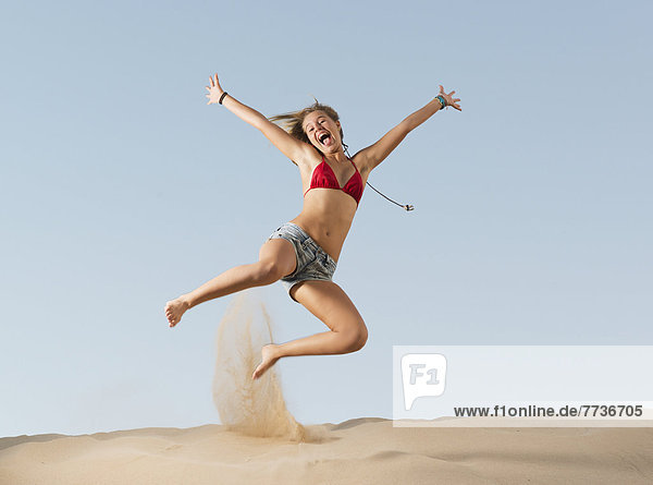 A girl jumping on the beach  tarifa cadiz andalusia spain