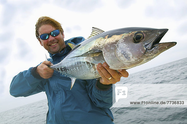 Man holding fresh caught bluefin tuna  massachusetts united states of america