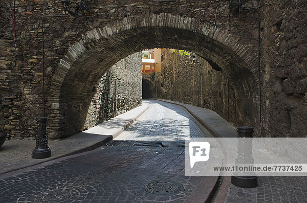 Archway over cobblestone streets Guanajuato mexico