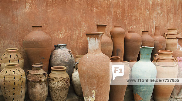 Variety of clay pots against a wall Morocco