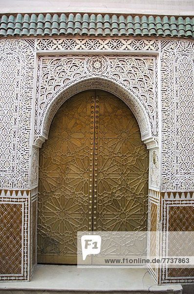 Ornate facade on walls and door of a building Marrakech morocco