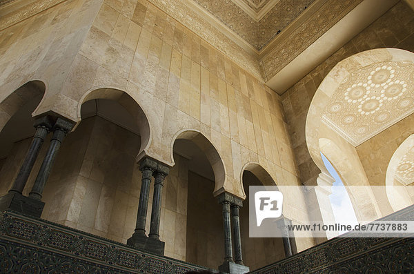 Ornate facade on walls with arches and pillars in hassan ii mosque Casablanca morocco