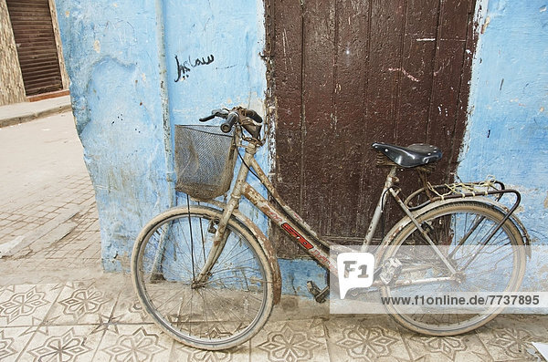 A bicycle leaning against a weathered wall Casablanca morocco