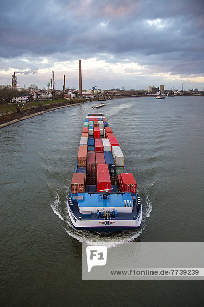 Container ship on the Rhine travelling upstream at Duisburg-Homberg